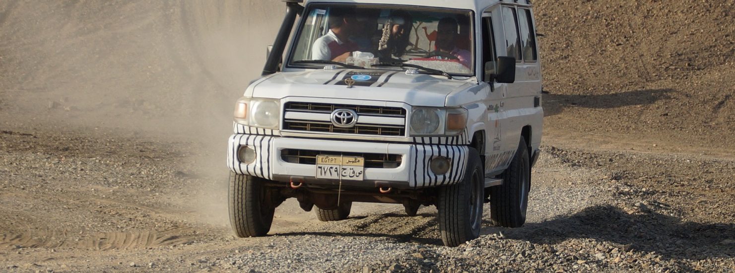 riding a white SUV