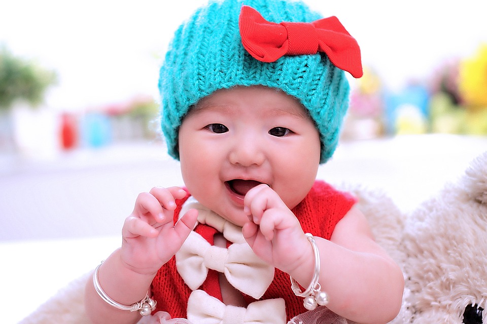 cute baby with a cyan colored bonnet